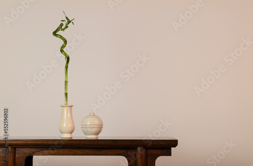 Bamboo, Chinese antique ceramics on wooden table against white wall