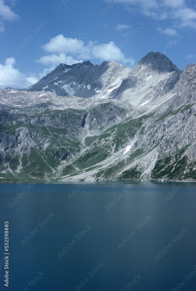 Natural landscape with high mountain peaks of the Rhaetikon in the Eastern Alps at the Luener Lake in Austria