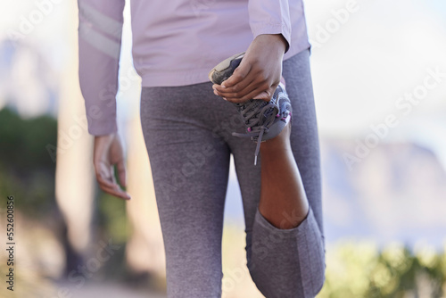 Stretching, running and shoes of black woman in nature for training, fitness or cardio endurance. Stamina, jogging and workout with girl runner and warm up on mountain path for exercise performance