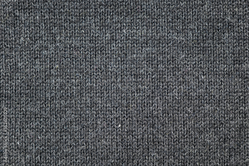 Surface of warm winter knitted gray sweater as background or texture, top view Surface of warm winter knitted gray sweater as background or texture, top view