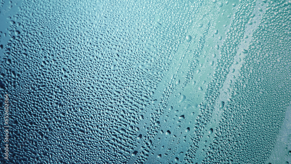 Condensation on window glass in frosty winter weather. Background in the form of small drops on the glass.
