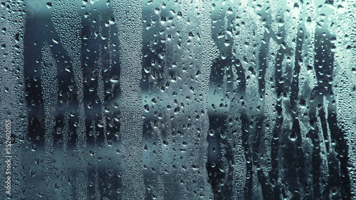 Condensation on window glass in frosty winter weather. Background in the form of small drops on the glass.