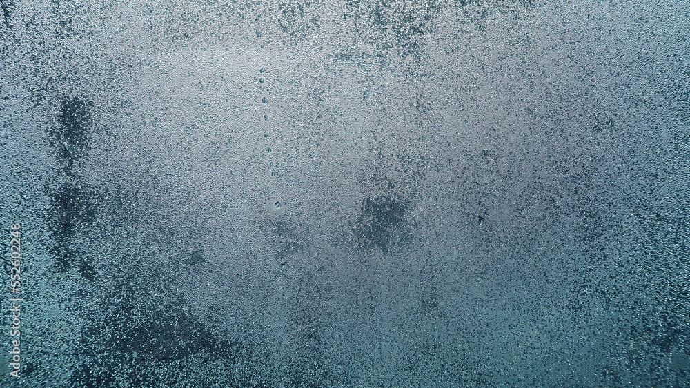 Condensation on window glass in frosty winter weather. Background in the form of small drops on the glass. - obrazy, fototapety, plakaty 