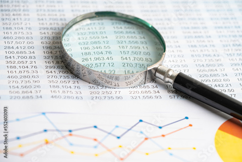 Magnifying glass on charts graphs paper. Financial development  Banking Account  Statistics  Investment Analytic research data economy  Stock exchange trading  Business office concept.