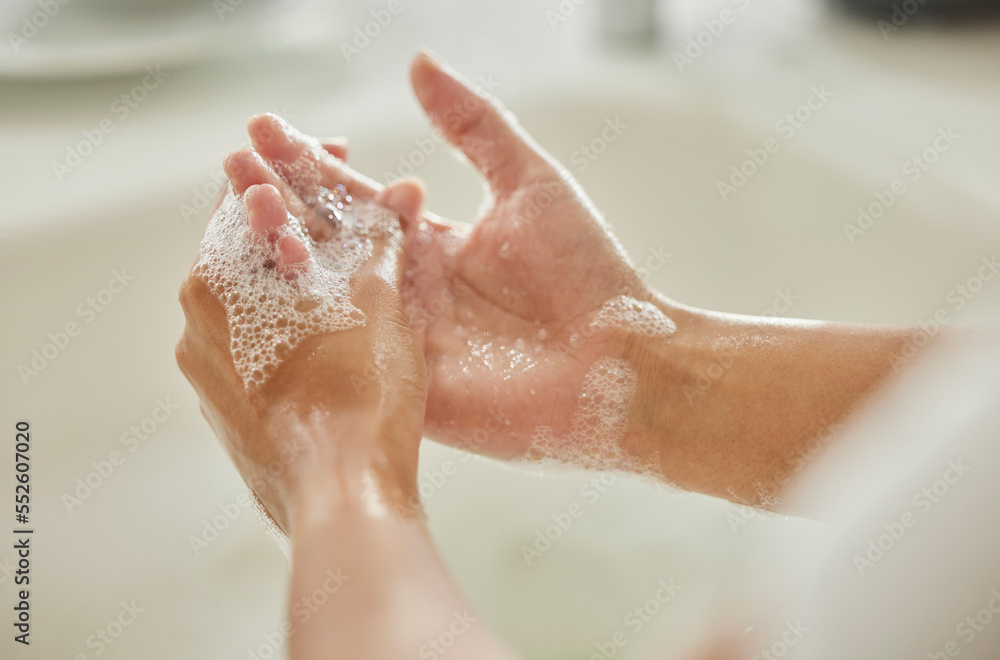 Fototapeta premium Woman, cleaning and hands with soap, bubbles or water in bathroom for hygiene, healthcare or safety. Hand washing, foam and clean from germs, virus or bacteria for wellness, healthy skin or self care