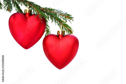 Isolated Christmas heart toy on a Christmas tree. Two hearts on a spruce branch