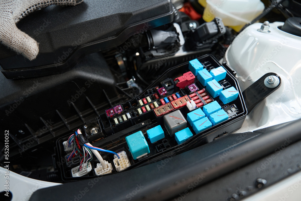 Close up photo of man checking details of automobile