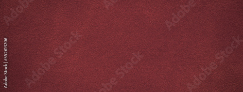 Texture of dark red velvet matte background, macro. Suede wine fabric with pattern. Seamless textile leather backdrop,