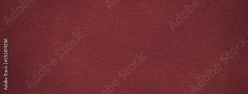 Texture of dark red velvet matte background, macro. Suede wine fabric with pattern. Seamless textile leather backdrop,