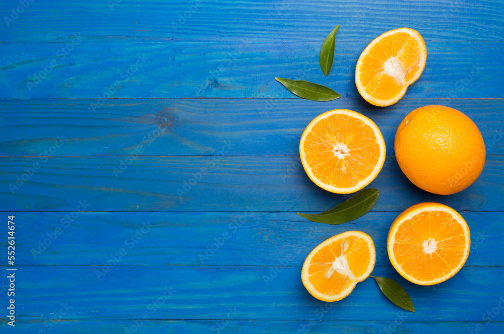 Fresh oranges with leaves on wooden background Fresh oranges with leaves on wooden background