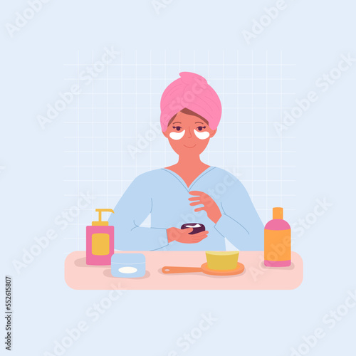 A woman in the bathroom with patches under her eyes.