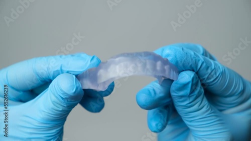 Dental transparent plastic mouthguard, splint for the treatment of dysfunction of the temporomandibular joints, bruxism, malocclusion, to relax the muscles of the jaw. photo