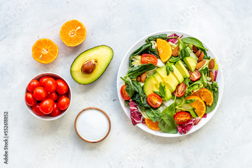 Bowl of green salad with avocado and tomatoes. Healthy vegetarian lanch