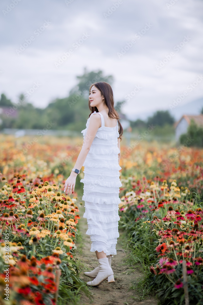 Beautiful young woman in white dress in flower garden at Chiang Mai, Thailand Beautiful young woman in white dress in flower garden at Chiang Mai, Thailand