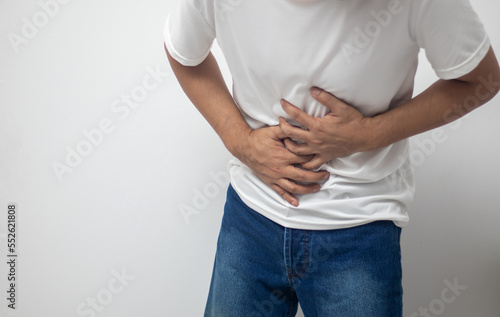 man having abdominal pain on white background