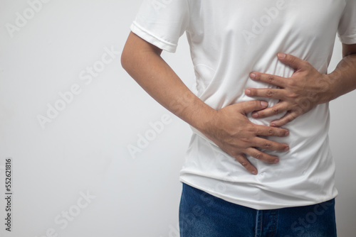 man having abdominal pain on white background