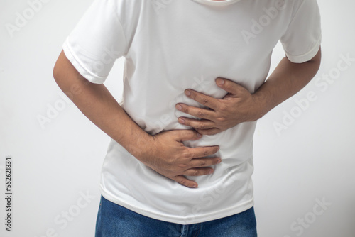 man having abdominal pain on white background