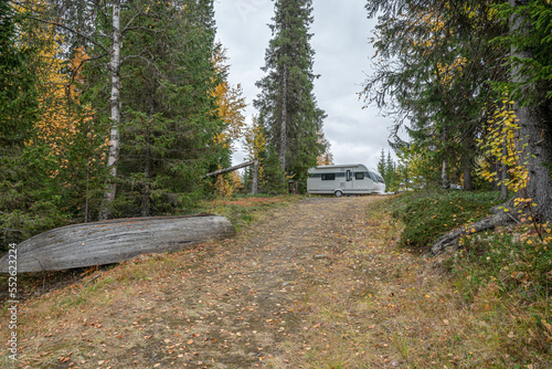 camping caravan near river autumn fall landscape along Ammarnas National Park in Lapland Sweden photo