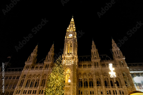 Vienna City Hall and its Christmas tree at night. Christmas decorations and lights of the city of Vienna in Austria.