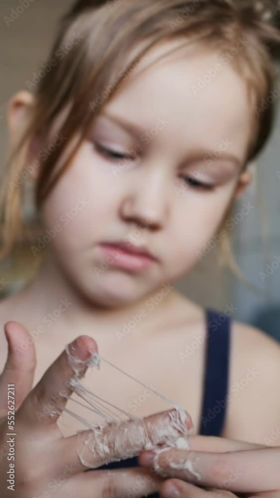 Portrait a teenage girl picked up a used chewing gum and her fingers