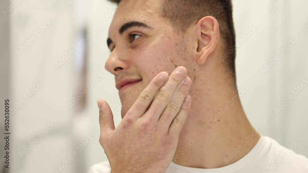 Man use shaving foam at bath. Handsome male in white t-shirt. First fime shaving. Close-up Man use shaving foam at bath. Handsome male in white t-shirt. First fime shaving. Close-up