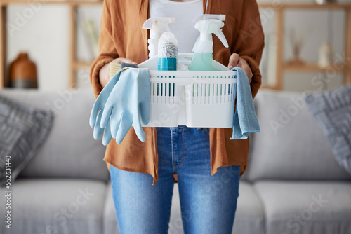 Zoom, woman hands with cleaning, product in basket for home maintenance, cleaning service or living room spring cleaning. Cleaner or maid with brush, liquid spray bottle or clean supplies in hand photo