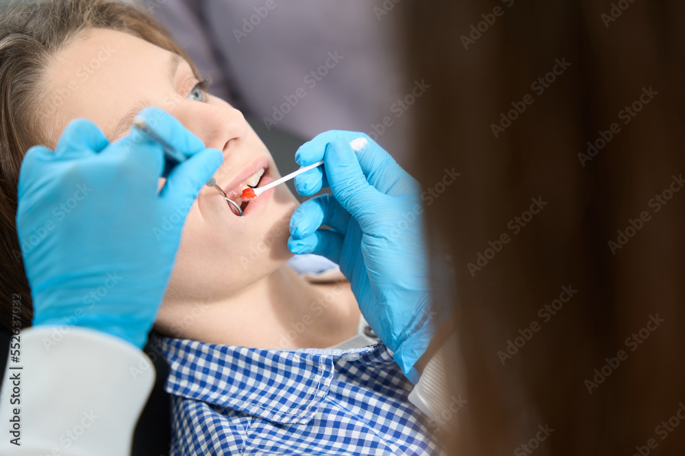 Dentist makes child application anesthesia with special red paste