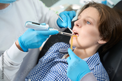 Child in a dentist chair receives an ambulance for toothache