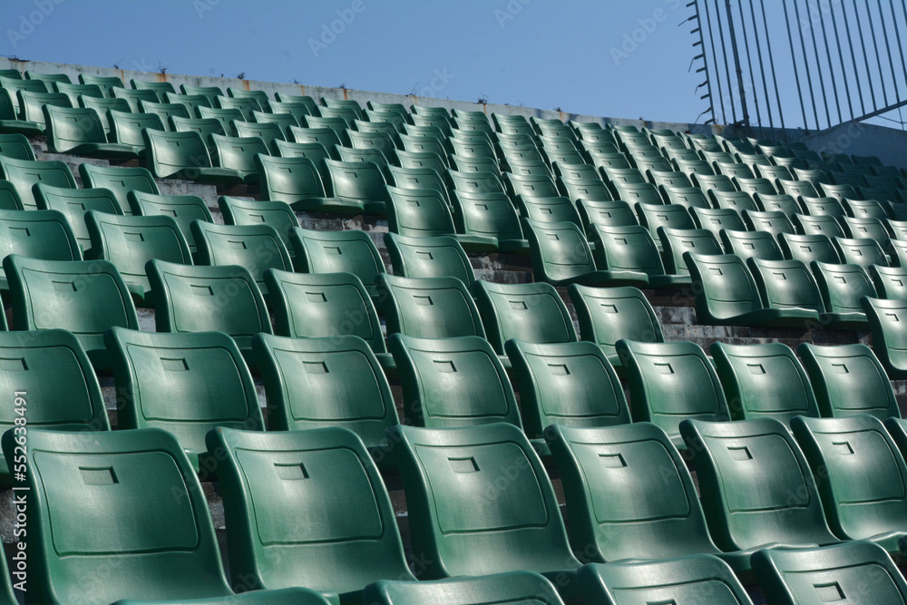 Fototapeta premium Green chair on stadium. To watch a sporting event.