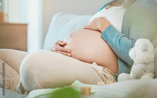 Pregnant, stomach and mother bond with her baby while resting during maternity at home. Tummy, belly and pregnancy with a mommy to be holding her abdomen and caring for her kid while relaxing