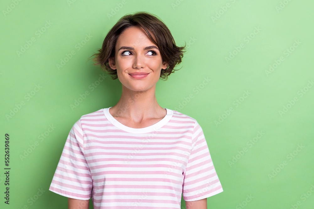 Photo of lovely bob hairdo young lady look promo wear white striped t-shirt isolated on green color background Photo of lovely bob hairdo young lady look promo wear white striped t-shirt isolated on green color background
