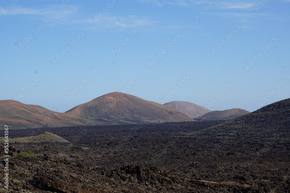 Obraz premium volcanic landscapes of lanzarote, photographed in november 2022. trekking day trip. Crater, volcano, sea of lava, solidified lava, landscape, sony a6000