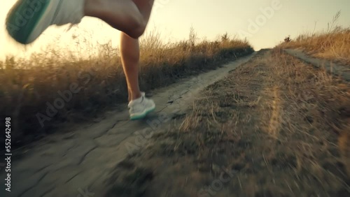 runner running along dirt road photo