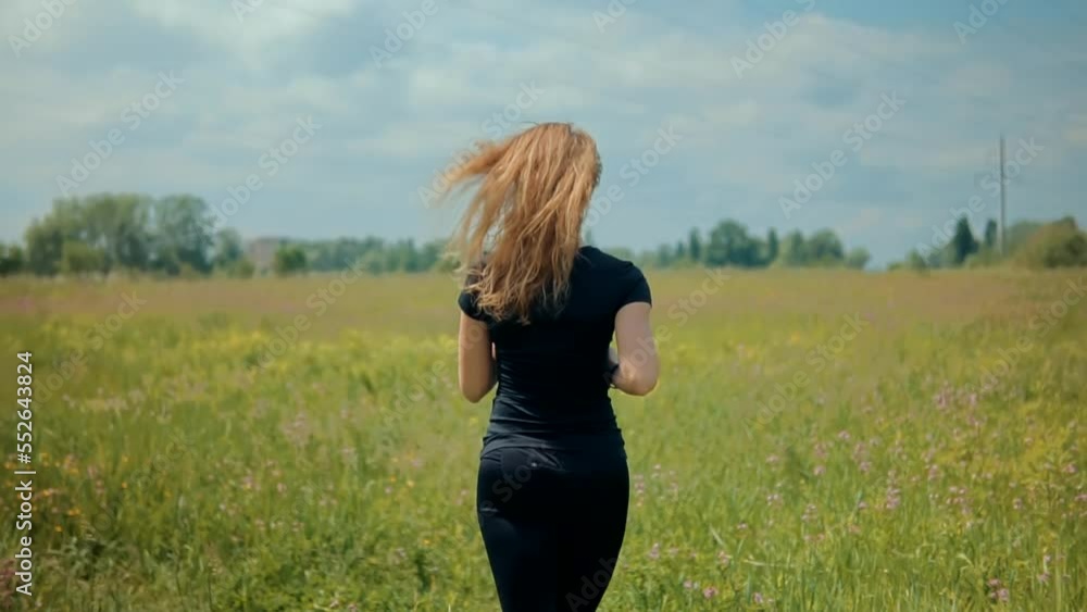 A runner is working out on a grass field A runner is working out on a grass field