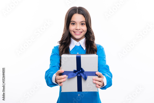 Young teenager girl child holding gift box isolated on white background. Gift for kids birthday.