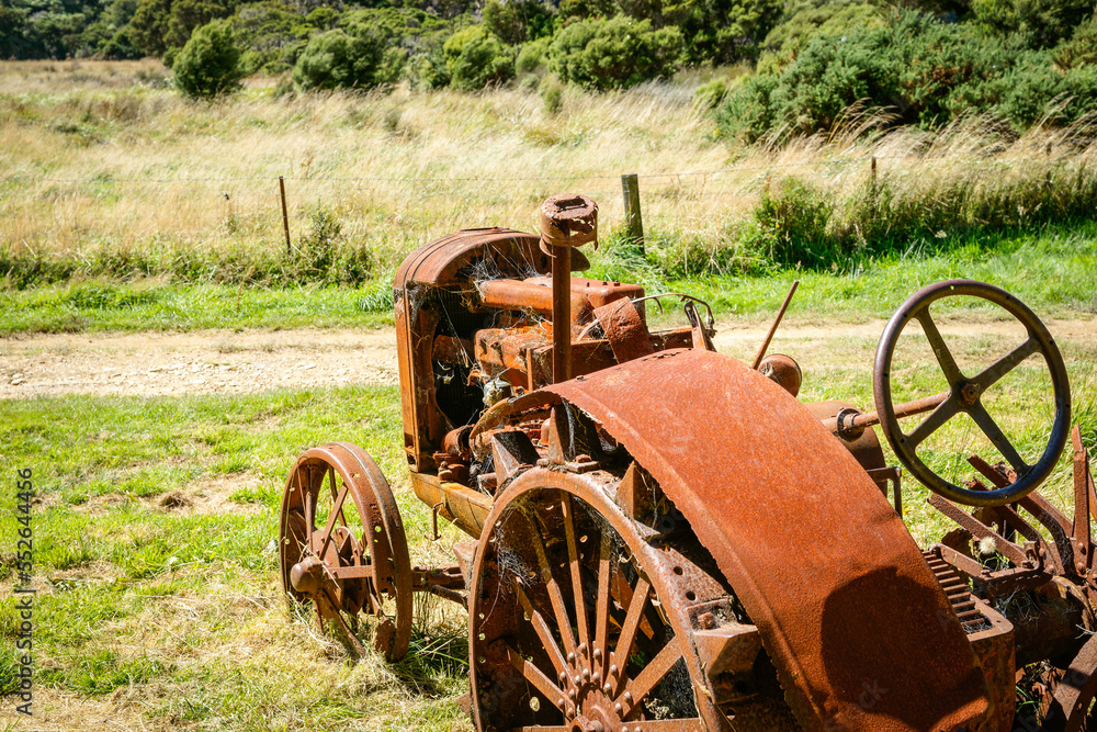 Vintage agricultural tractor deserted and rusting away