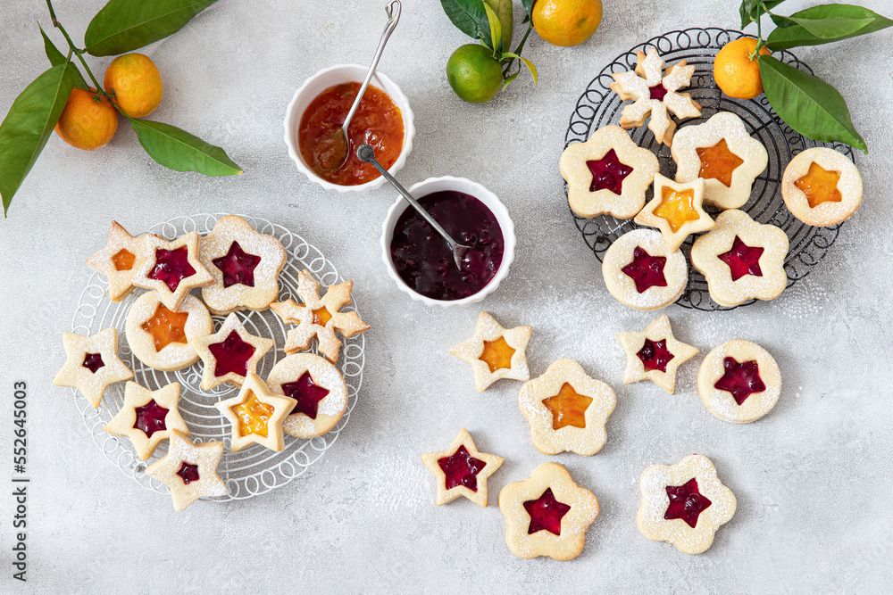 Traditional Linzer Christmas cookies filled with lingonberry jam and orange jam	