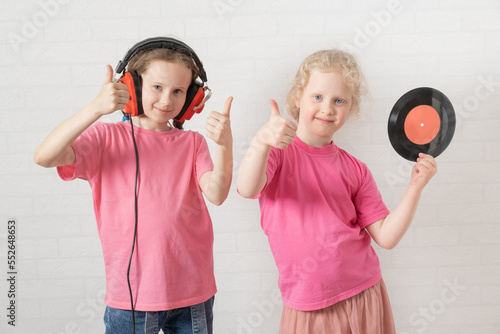 cute little girl with earphones and vinyl record