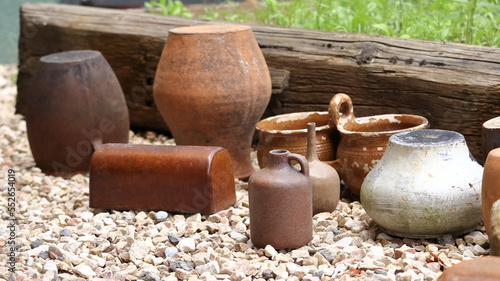 Clay pots arranged in a row as a decoration, an ornament in the garden.