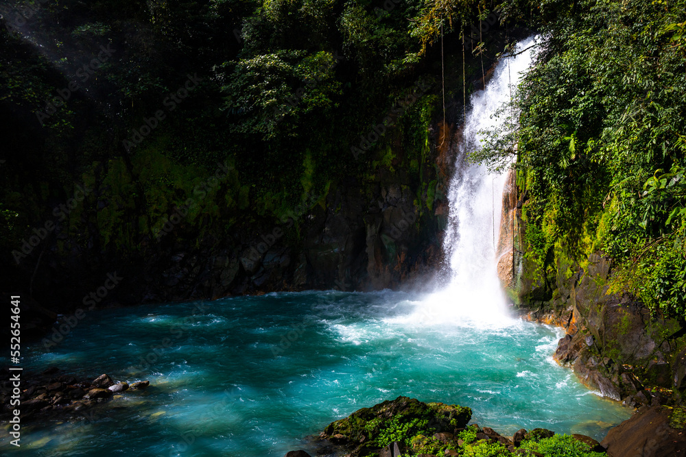 Fototapeta premium panorama of the famous rio celeste waterfall in volcano tenorio national park in costa rica; a blue waterfall in a tropical rainforest