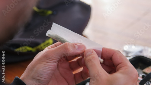 White man rolling a joint closeup