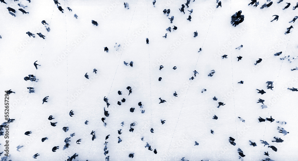 People Skating on an Open-Air Ice Skating Rink. Top view. Many People Skating on Ice of Rink. Aerial Drone View. Beautiful Skating Sport and Winter Outdoor Activities Background Blue color People Skating on an Open-Air Ice Skating Rink. Top view. Many People Skating on Ice of Rink. Aerial Drone View. Beautiful Skating Sport and Winter Outdoor Activities Background Blue color