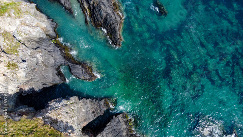 Turquoise waters of the Atlantic Ocean and large coastal cliffs. Beautiful seascape, top view.
