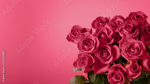 Festive blurred pink red background with a bouquet of gorgeous magenta roses