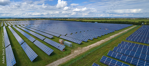 Aerial view of large sustainable electrical power plant with rows of solar photovoltaic panels for producing clean electric energy. Concept of renewable electricity with zero emission