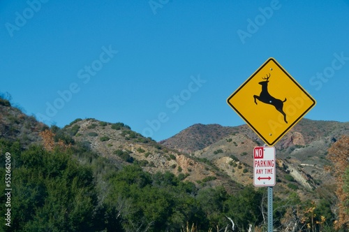 Deer crossing sign Malibu hills California blue sky © David