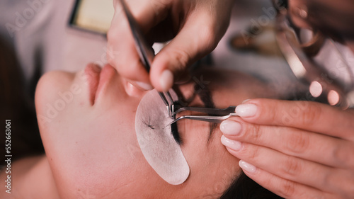 Gluing eyelashes in a beauty salon close-up