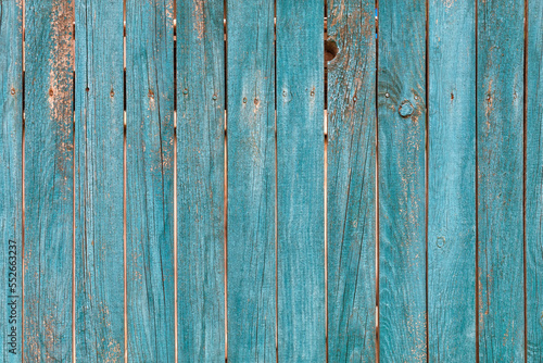 Old wooden fence with faded green paint texture.