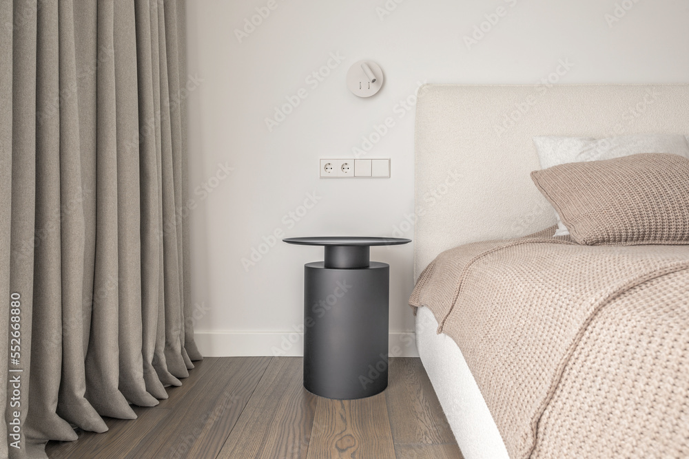 White wall lamp above the bed, metal beside table, white electrical outlet,  oak wooden floor..Modern minimalist aesthetic bedroom interior design in  warm shades Stock Photo | Adobe Stock