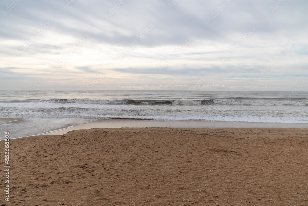 Frontal views of waves from the beach. A cloudy day.